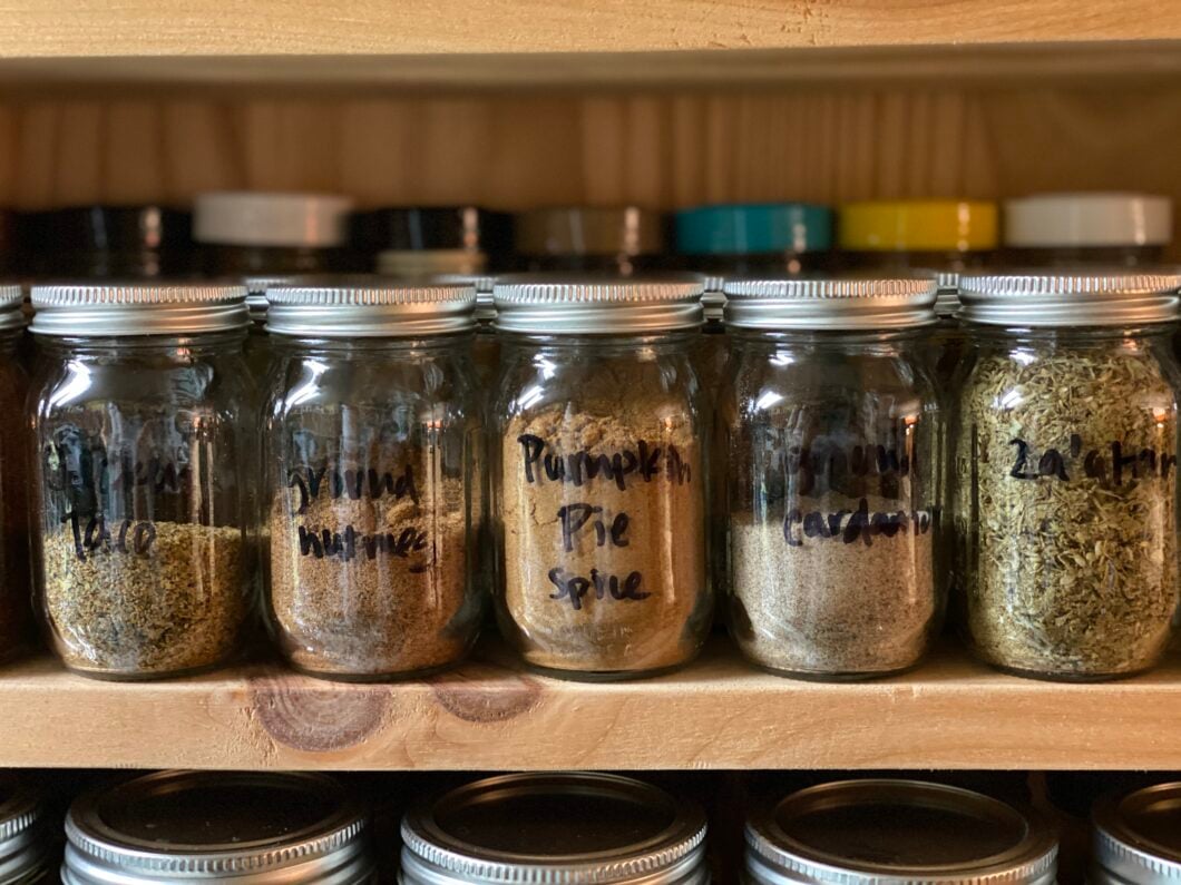 Close up of Ball® Mini Storage Jars filled with spices. 