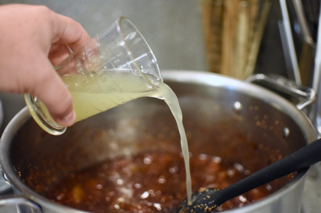 Adding 1/3 cup lemon juice to the cooking fig jam.