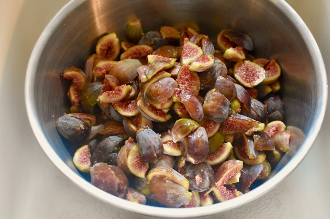 A large bowl filled with quartered figs